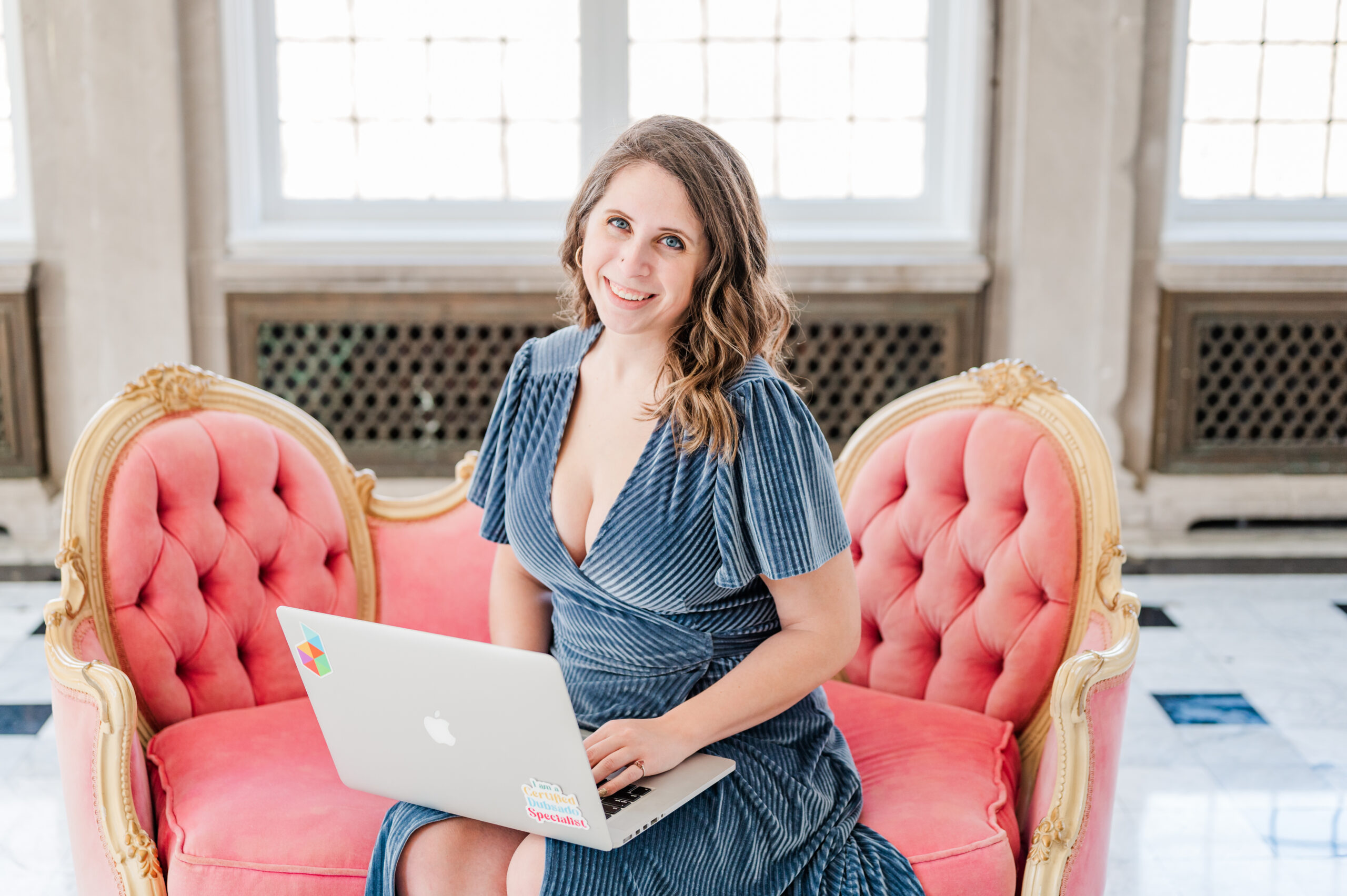 Cait Potter, systems strategist, working on a laptop
