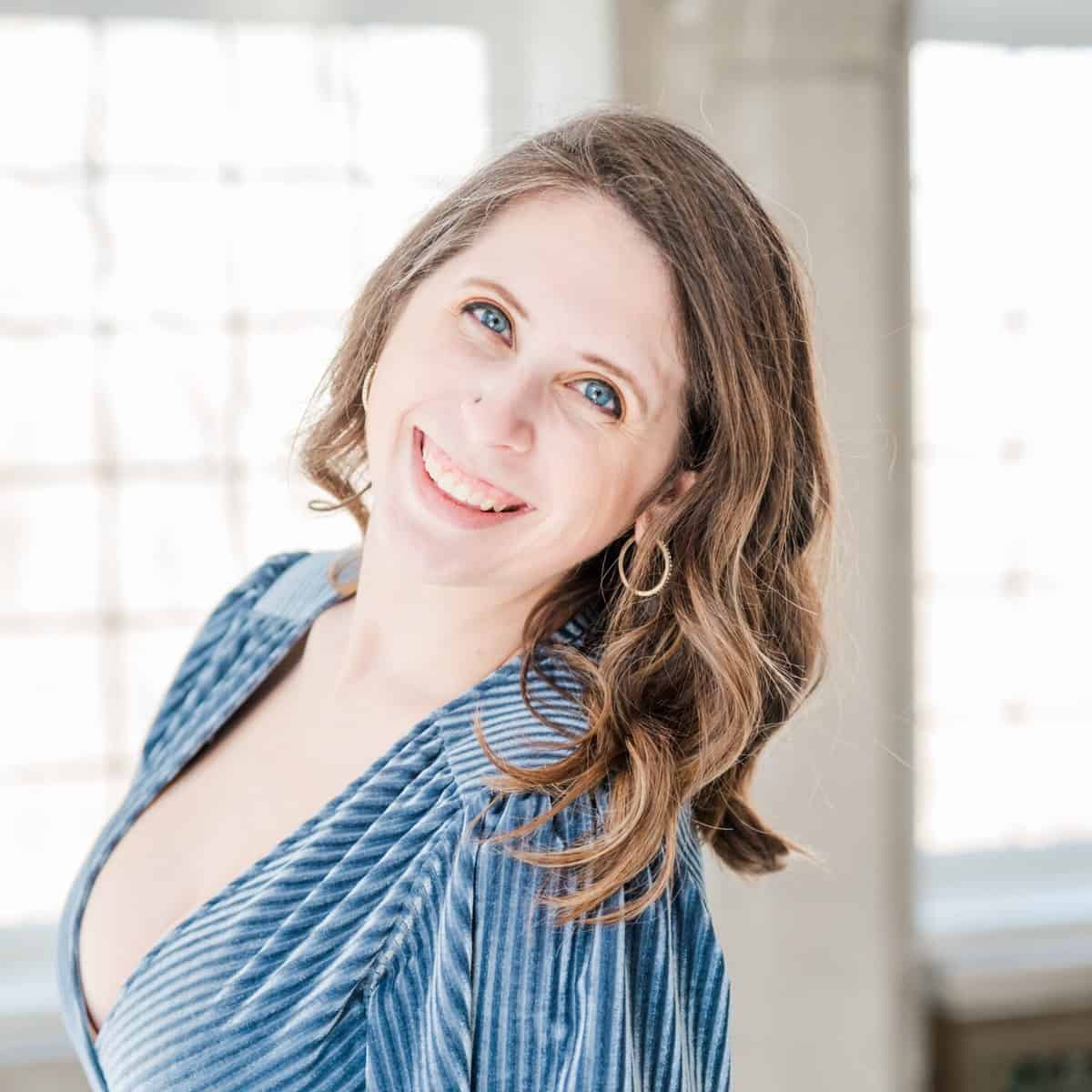 Cait Potter in a blue dress, smiling