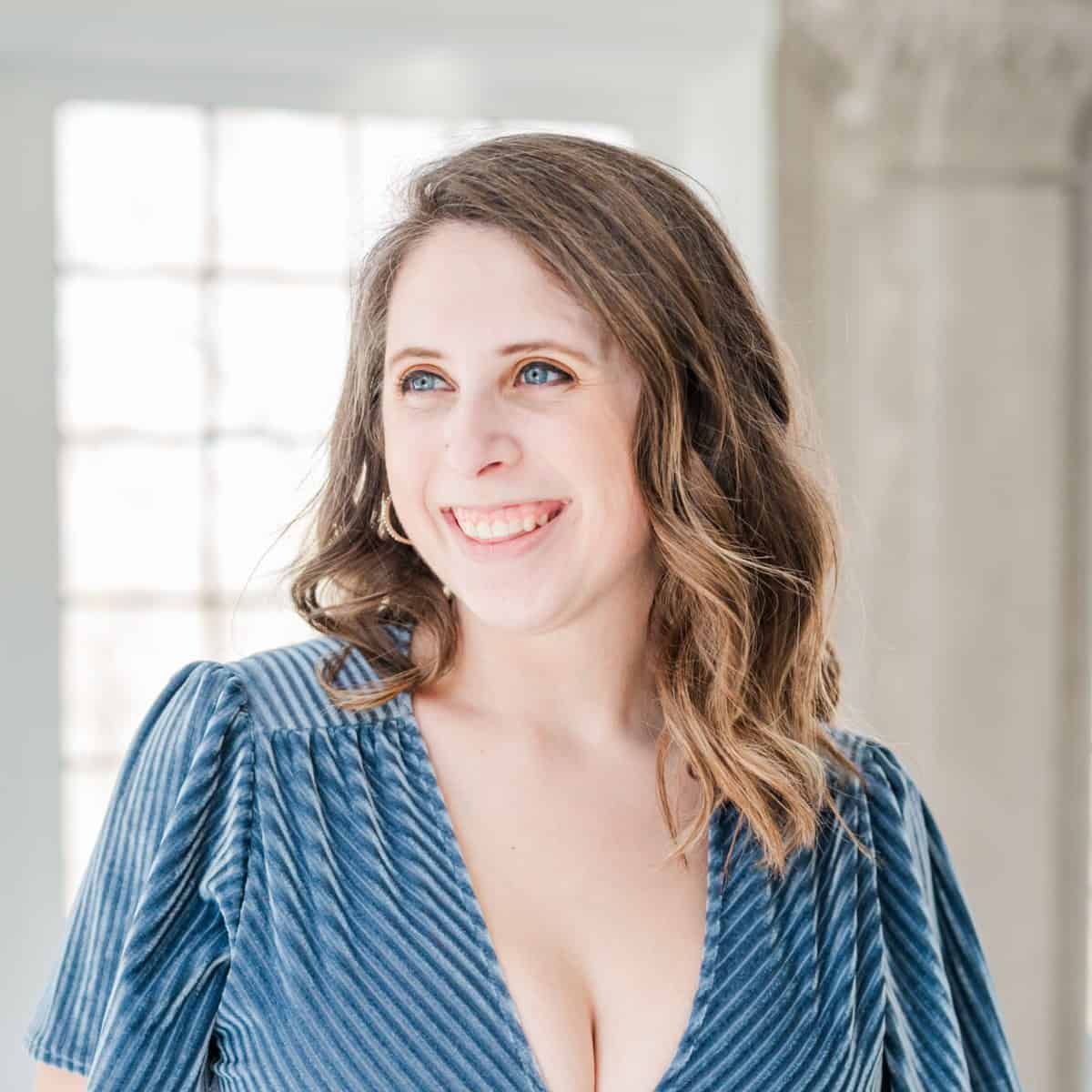 Cait Potter in a blue dress, smiling