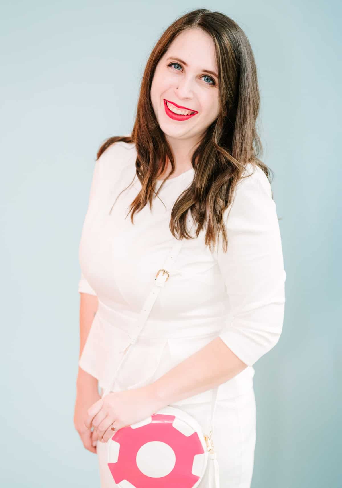Cait Potter in a white tailored dress, smiling